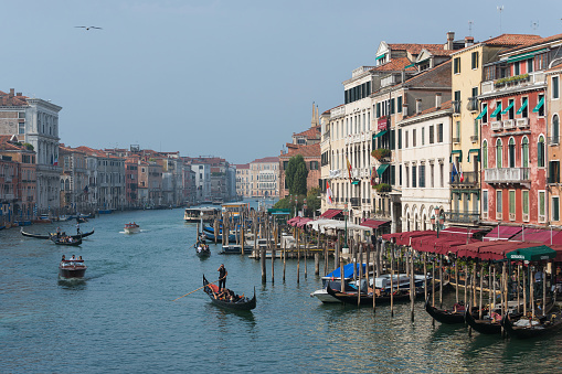 Venice, Italy - September 24, 2021: View of Grand Canal in late and hazy September. The Grand Canal (Italian: Canal Grande) is a channel in Venice, Italy. It forms one of the major water-traffic corridors in the city.