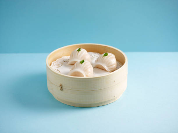Steamed Prawn Dumpling Ha Kau served in a wooden bowl isolated on mat side view on grey background