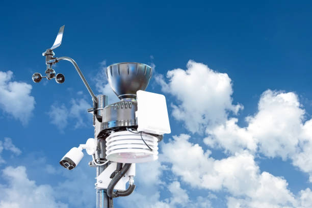 automatic weather station, with a weather monitoring system and video cameras for observation. against the background bright sun and summer cumulonimbus clouds. - anemometer meteorology measuring wind imagens e fotografias de stock