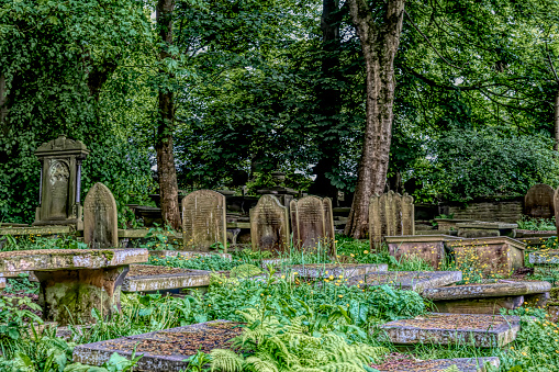 Haworth churchyard with headstones, this is beside the Bronte Parsonage and church where Anne, Emily and Charlotte Bronte lived and wrote.