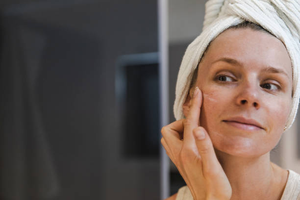 istock Woman Applying Moisturizing Face Cream 1406220996