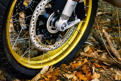 Close up of the modern motorcycle wheel on an unpaved road