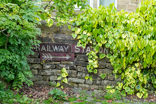Sign towards the Railway station in Haworth, Yorkshire, England, UK