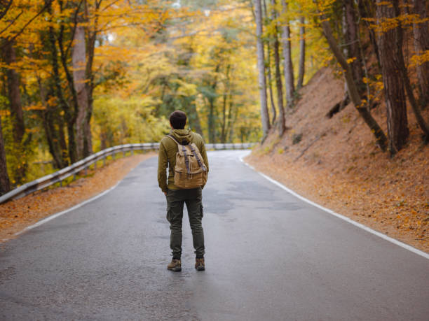 istock Young handsome man posing in autumn forest. 1406222225