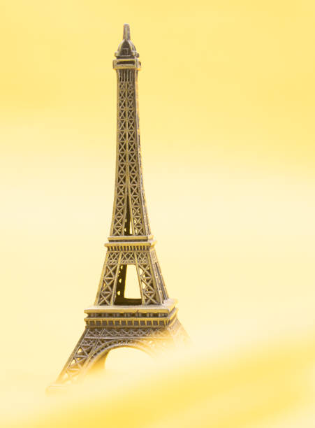 istock Eiffel Tower model, Paris, France. Isolated in yellow background 1406223600