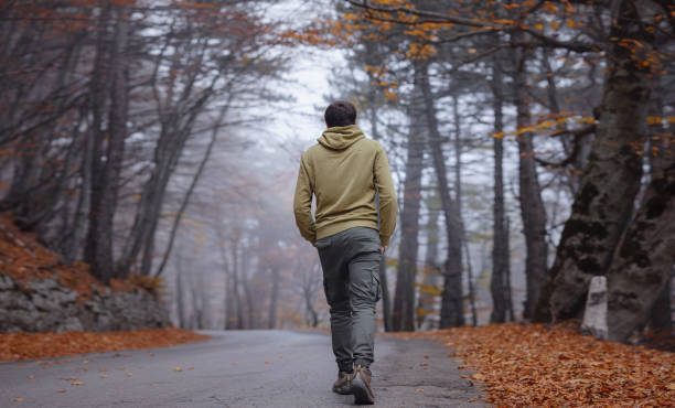 istock Young handsome man posing in autumn forest. 1406226363