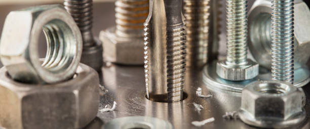 istock Thread tap drill steel billet with drill bit on background. Working cutter. 1406227369