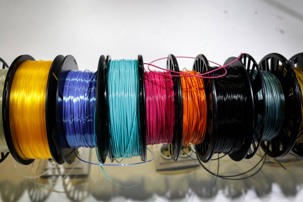 istock Top view of Colorful plastic PLA and ABS spools with thread for printing on a 3D pen 1406232028