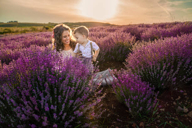 istock Mother bonding with son in lavender field at sunset 1406233715
