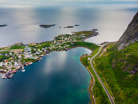 Scenic fjord landscape with Reine village, coast nature with road along sea shore, Lofoten islands North Norway. Travel destination.