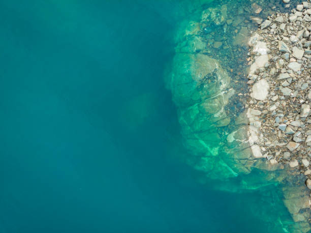 istock Blue water and rocks, view from above 1406234894