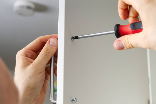 istock Professional Furniture Assembly Worker Assembles Shelf. Furniture assembly process. DIY Assembling 1406234940