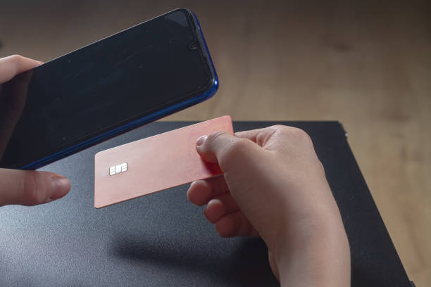istock Pay with a plastic card via a smartphone, pay for a purchase from a courier 1406235718