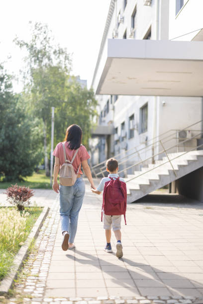 istock Mother walking her son to school 1406237157