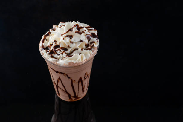 istock Chocolate milkshake served in a clear glass on a dark background. Isolated drink. 1406237167