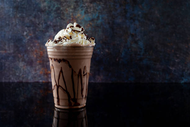 istock Chocolate milkshake served in a clear glass on a dark background. Isolated drink. 1406237178