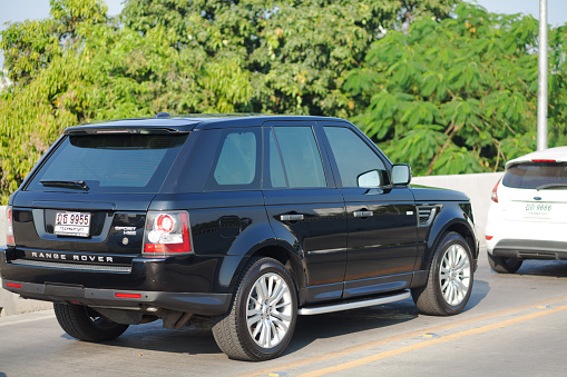 Black colored Land Rover Discover Sports Edition SUV in traffic queue in Bangkok