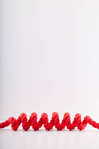 istock Red rope with a spiral Isolated on white background. 1406238600
