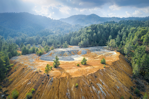 Restoration of abandoned mine site. Pine trees growing over copper and gold mine tailings in Paphos forest, Cyprus