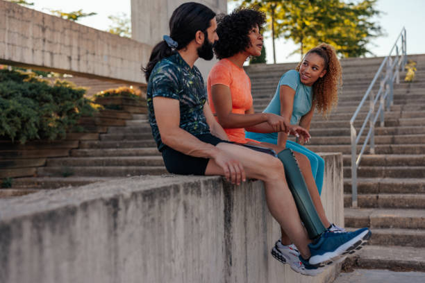 istock Athletes sitting on wall in urban area 1406241542