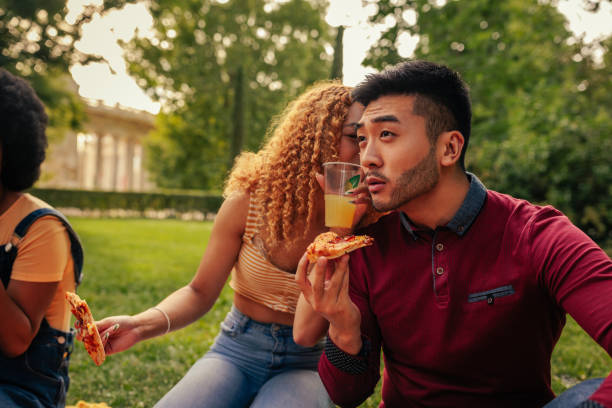 istock Friends chatting on picnic in park 1406242461