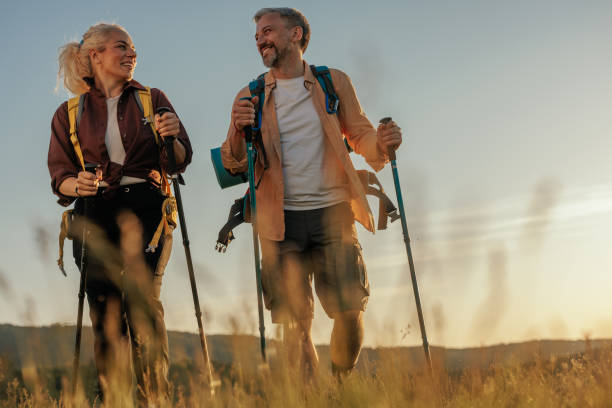 istock Smiling middle age couple hiking together 1406242528