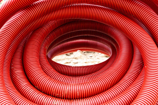 red corrugated pvc pipe for underground electrical cable laying stock photo
