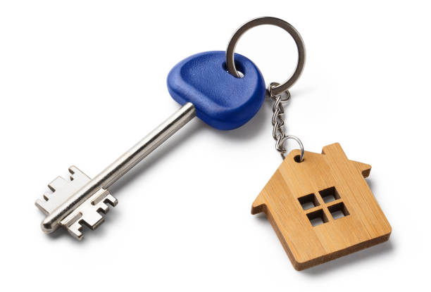 istock House key with house shaped keychain on white 1406244720
