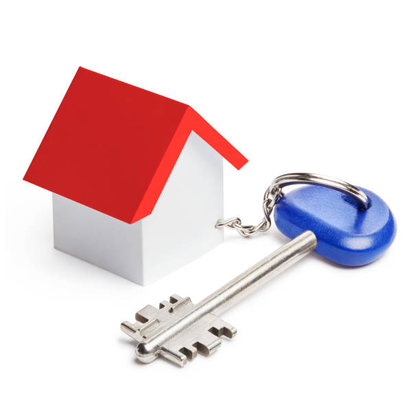 istock House key with house shaped keychain on white 1406244746