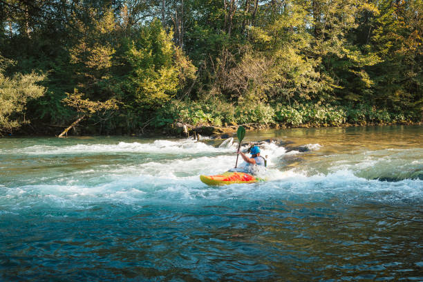 istock Man kayaking over the mountain river rapids 1406244770