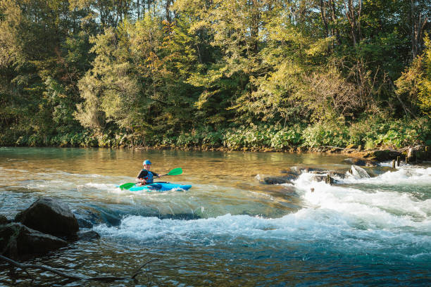 istock Male kayaker paddling over the whitewater rapids 1406244772