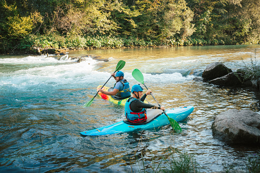 Whitewater kayaking, extreme kayaking. A guy in a kayak sails on a mountain river