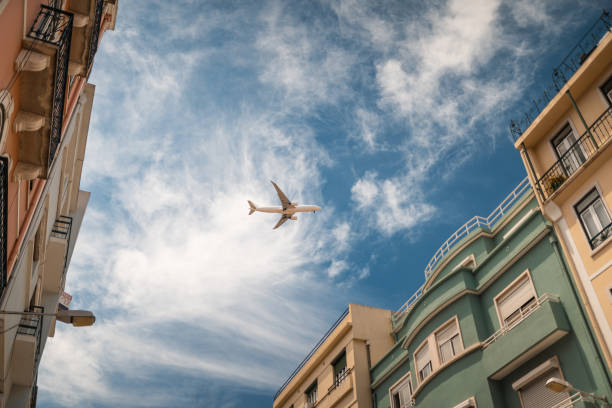 Airplane flying over Lisbon stock photo