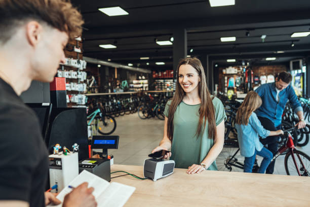 istock woman making a payment in bicycle store 1406249348
