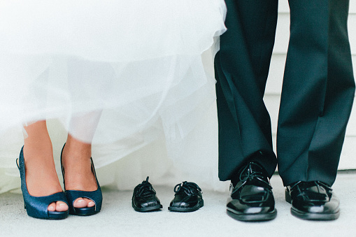 Bride and Groom with child shoes.