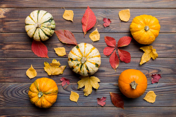 istock Autumn composition. Pattern made of dried leaves and other design accessories on table. Flat lay, top view 1406250170