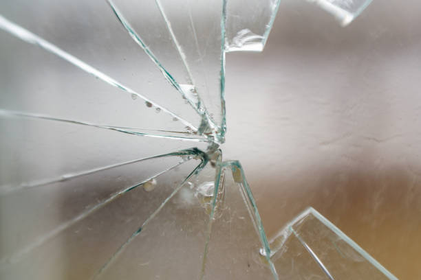 istock Glass broken by hooligans in a metal-plastic window, close-up 1406252310