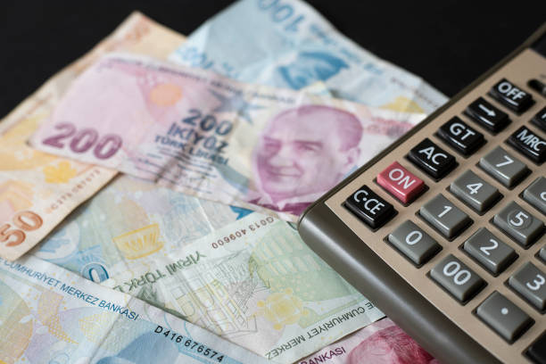 istock Turkish Liras and calculator on black background. 1406252428
