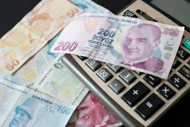 istock Turkish Liras and calculator on black background. 1406252463