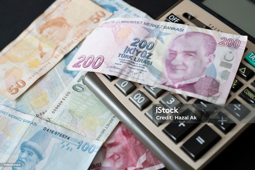 Turkish Liras and calculator on black background. Turkish Lira Stock Photo