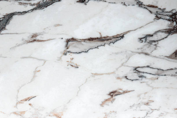 istock White marble stone texture top view. abstract pattern with grey and brown streaks for background or design art 1406252591
