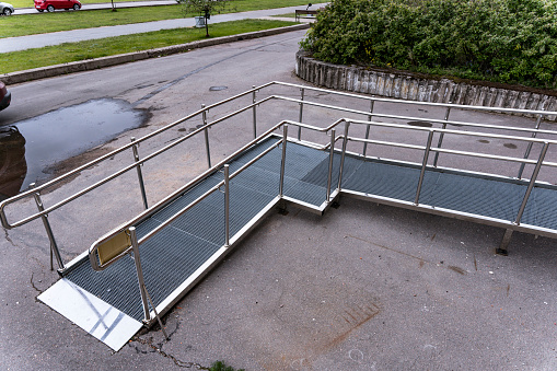 A ramp for people with disabilities near a public building. An iron ramp for the disabled.