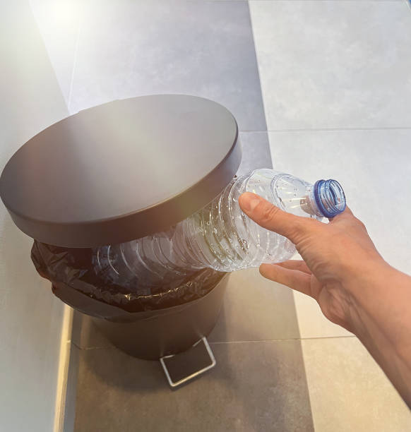 istock Throwing plastic bottle in the trash in the office 1406255638