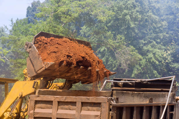 istock An excavator is loading earth into a dump truck, which is heavy construction equipment 1406255727