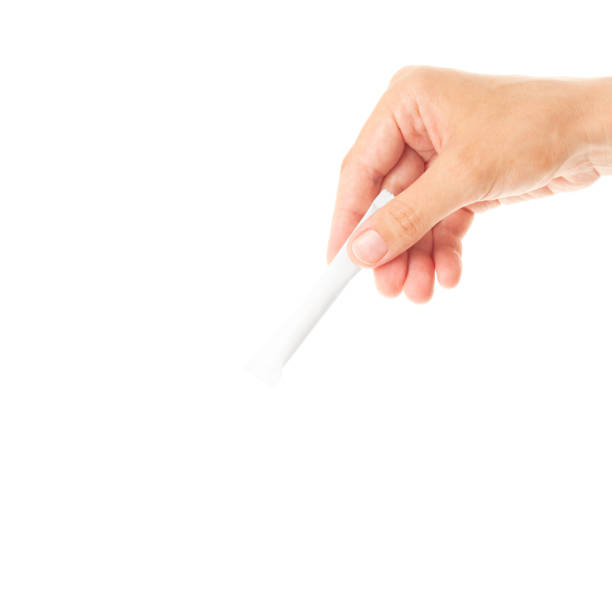 The right hand holds the stick pack.