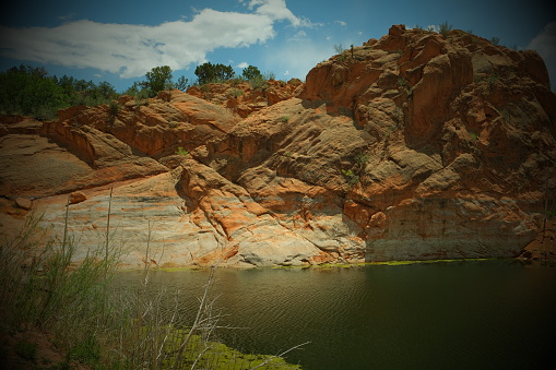Cliff hanging over a pond in Colorado