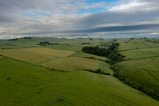An aerial view green glades and glens in northern England neare the Scottish Borders