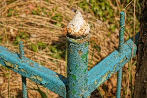 istock part of a green small metal decorative fence with white rusty sharp iron bars 1406263793