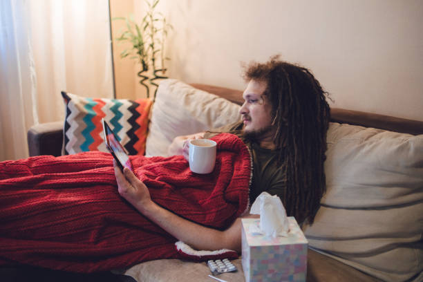 istock Young ill man having interaction with doctor over digital tablet 1406266750
