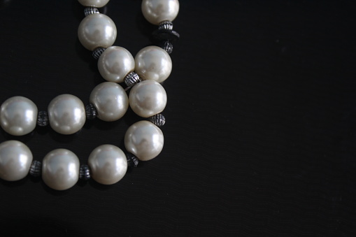 pearl beads on black background